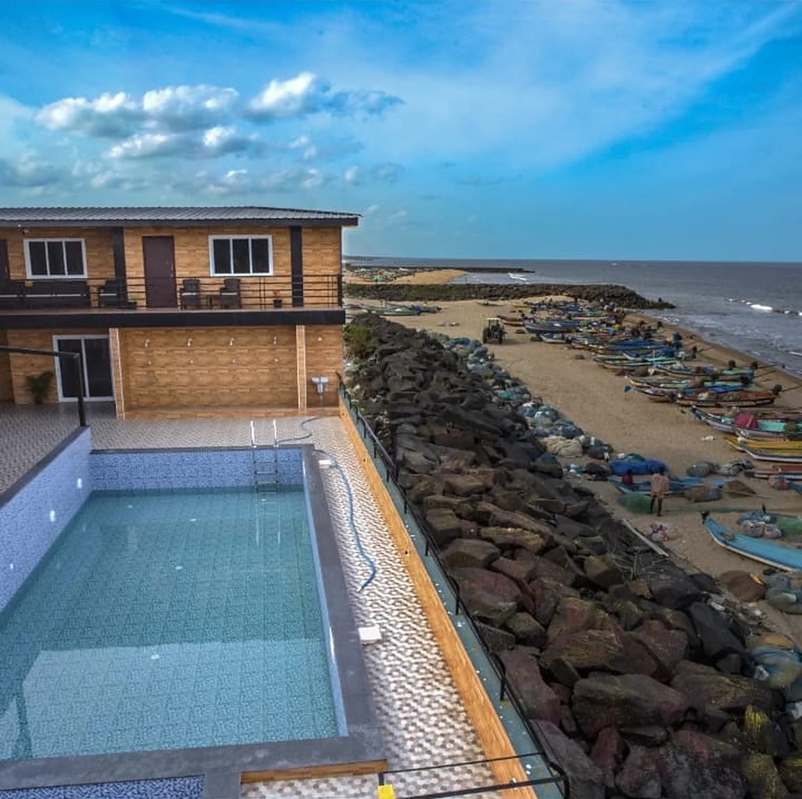 Pool with the beach beside it